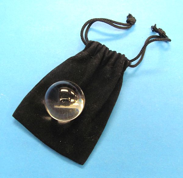 small crystal ball in drawstring bag