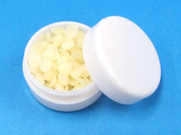 magician's wax in small white plastic container