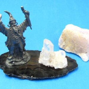 pewter wizard figurine standing alongside crystal formation